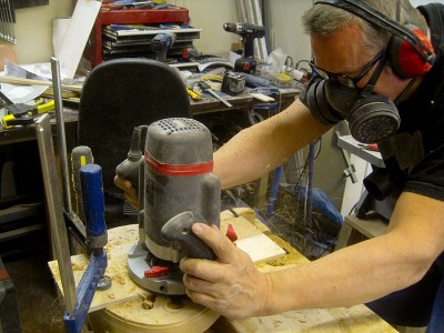 Routing the swimming pool type pickup cavity with a copy router bit and a plywood template. A big cavity may pick up a bit more hum than a snug one, but shielding it carefully helps a lot and I can install any combination of pickups there.