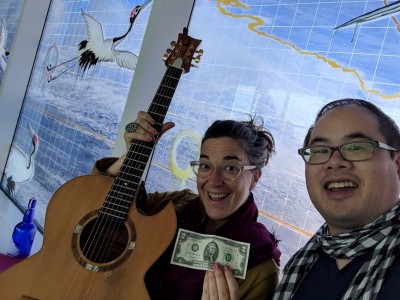 The $2 bill was a tip from a airline pilot passing us by.  Good music, and possibly the most enjoyable airplane wait ever.