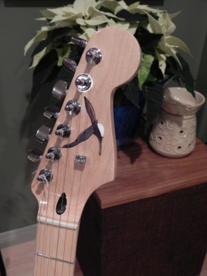 A closeup of the headstock and my first try at inlaying.