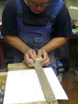 Radiusing the fretboard here. I've made 12&quot;, 16&quot; and 20&quot; radius sanding cauls for the job and most frequently use the 16&quot; caul. They all have hook side velcro glued to the arch and I can use any sanding paper with velcro fastening with them.