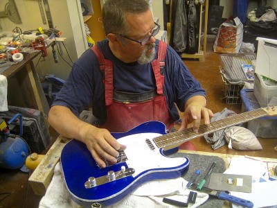After stringing the guitar and tuning it I set the intonation using a clip-on tuner.
