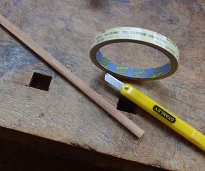 The tools to make the &quot;file for shaping the windway roof. A shaped piece of hardwood, a double-sided tape, and snap-off craft knife. Oh, and sandpaper. I use P120 for the rough shaping, and finer for finishing.